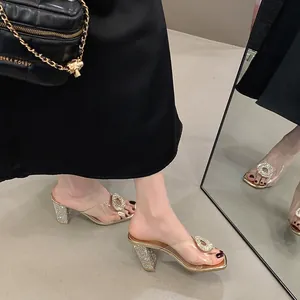 Elegant clear PVC mules with rhinestone buckle and shimmering chunky heels