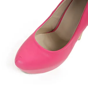 Detail shot of vibrant pink platform high heel pump showing leather texture and round toe.