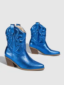 Close-up of metallic electric blue western boots with classic embroidery detail and chunky heel
