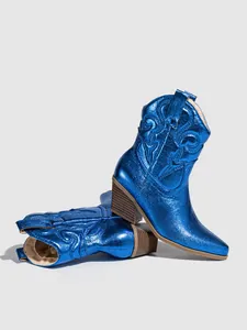 Detailed close-up view of metallic blue western boots with classic embroidered patterns