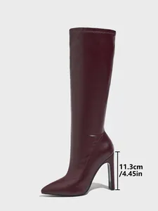 Professional detail shot of burgundy pointed toe high heel boot with 11.3cm heel