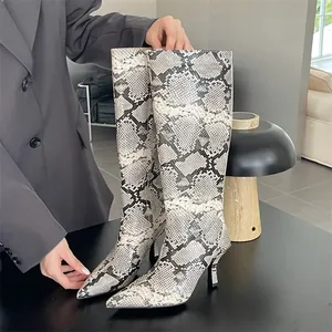 Detail of pointed toe stiletto knee high boots with elegant snakeskin pattern finish