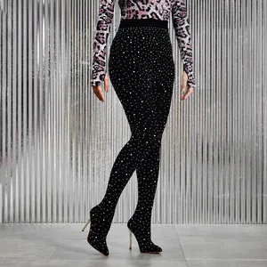 Close-up of black stiletto pant boots with sparkling rhinestone embellishments and pointed toe