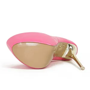 Macro detail showing the tan textured sole and golden stiletto heel of a pink platform shoe