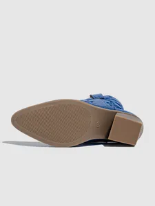 Detailed view of the sole and block heel of blue Western boots with embroidered patterns