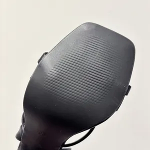 Detailed view of the anti-slip sole texture on square toe black high-heeled sandals.