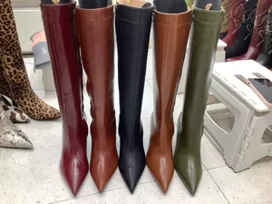 Row of women's vintage pointed-toe knee-high boots in diverse colors like olive and burgundy
