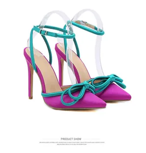 Purple and teal satin high-heeled shoes with bow detail and stiletto heel.