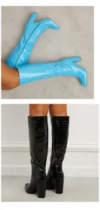 Close-up showing crocodile embossed texture on stylish blue and black high heel boots