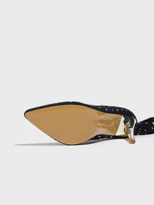 Detail shot of black rhinestone stiletto boot showing tan sole and gold heel.