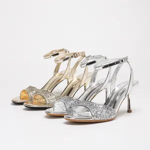 Elegant metallic glitter stiletto sandals with ankle straps in gold and silver, perfect for parties