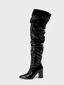 Glossy black patent leather slouchy over-the-knee boots with chunky heels and pointed toe