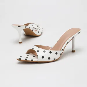 Stylish white polka dot pointed toe high heel mule sandals for women on white background
