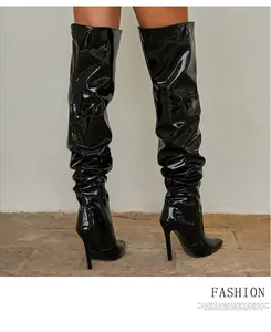 Slouchy black patent leather over-the-knee boots with high stiletto heels