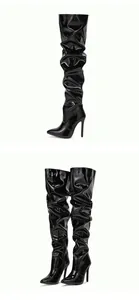 Detailed view of black slouched patent leather thigh-high boots with stiletto heels.