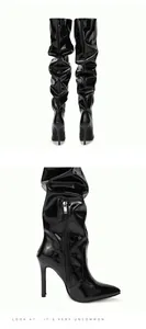 Side detail of black patent leather slouchy thigh-high boots with elegant stiletto heel
