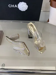Gold chunky heel sandals with transparent PVC strap and rhinestone buckle