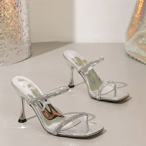 Elegant silver high heel sandals with sparkling rhinestone straps and a modern square toe