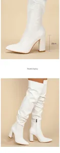 Detailed view of white slouchy over-the-knee boots with a stable 10cm block heel