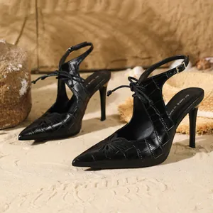 On feet & in love black stone-textured pointed toe slingback high heel sandals on sand