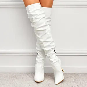 Elegant white slouchy over-the-knee boots with high heels and pointed toe.