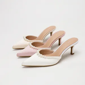 Elegant satin pointed-toe stiletto mules with pearl trim in white, pink, and cream