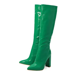 Fashionable green croc-embossed knee-high boots featuring pointed toe and chunky heels