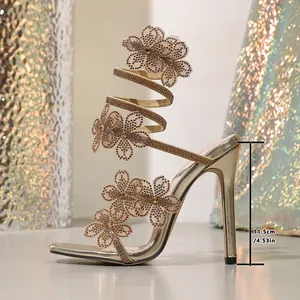 Detail showing 11.5cm heel height on gold rhinestone flower stiletto sandals.