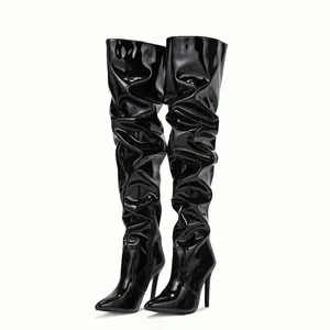 Elegant black patent leather thigh-high boots with ruched design and stiletto heels