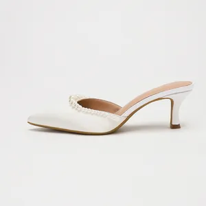 Elegant white satin pointed-toe mules with pearl embellishments and slim high heels