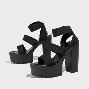 Side view detail of 14cm black platform high heel sandals with thick elastic straps.