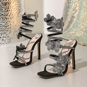 Elegant black square toe stiletto sandals with sparkling rhinestone flower wrap design