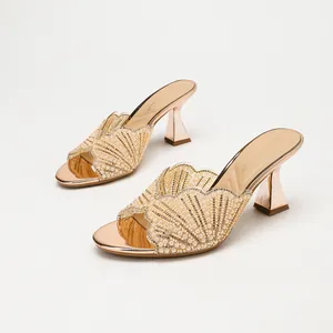 Elegant rose gold high heel mules with rhinestone scalloped strap and pearl accents.