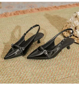 Elegant black patent leather pointed-toe slingback kitten heels with decorative buckle detail