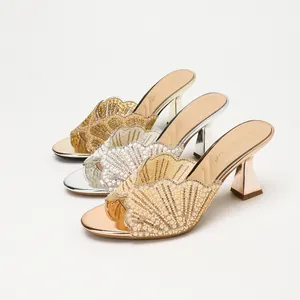 Elegant shell-shaped rhinestone high heel sandals in gold, silver, and rose gold.