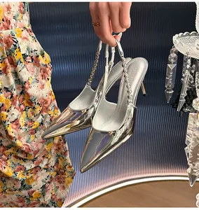 Close-up of elegant silver metallic high-heel stiletto pumps with rhinestone straps.