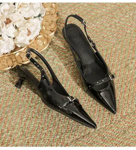 Elegant black patent leather pointed-toe slingback sandals with chic buckle detail