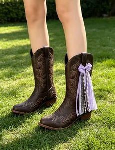 Detailed view of handmade purple ribbon bow and pearl tassel for Western boots