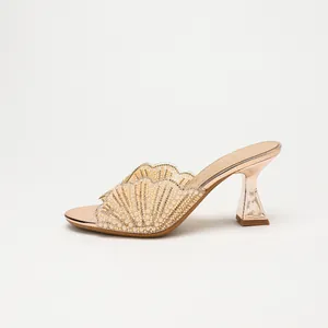 Elegant champagne gold high heel mules with pearl-embellished scalloped fan upper design.