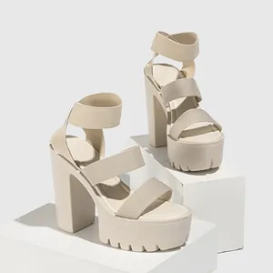 Side view showing details of beige platform sandals with thick elastic straps and chunky heels