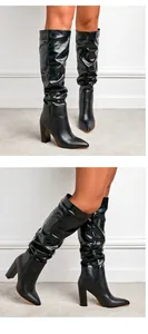 Detailed view of black slouchy high-heeled knee boots with pointed toe