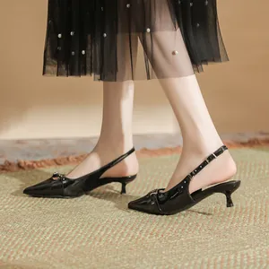 Women's elegant black patent leather pointed-toe kitten heel slingback shoes for fashion.