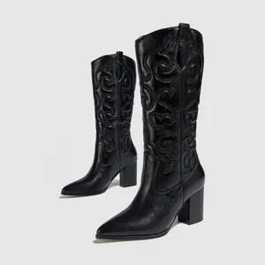 Detail view of black western cowboy boots with intricate embroidery and chunky heels