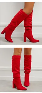 Vibrant red suede slouchy knee-high boots with high block heels and pointed toes