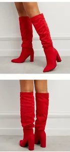 Stylish red suede slouchy knee-high boots featuring pointed toe and block heel details