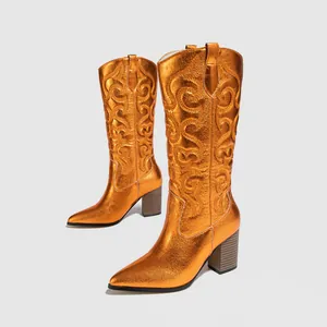 Side view detail of metallic orange embroidered western cowboy boots with block heel
