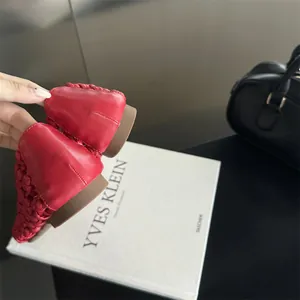 Close-up of red hollow woven flat shoe showing details of the heel and the texture.
