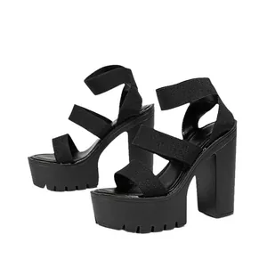 Side view of black platform chunky high heel sandals with elastic bands.