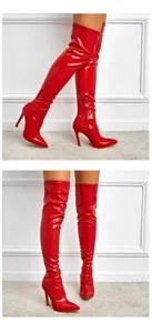 Detailed view of red crocodile pattern over-the-knee boots with stiletto heels