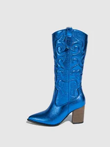 Close-up of metallic blue tall cowboy boot with detailed embroidery and pointed toe